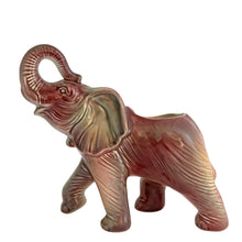 Load image into Gallery viewer, Vintage mid-century era figural lucky elephant ceramic plant in shakes of cranberry, green, yellow and gray. Marked Made in USA. Bring some luck to your gardening with this sweet, trunk up, planter!
In excellent condition, no chips/cracks/repairs.
Measures 9 x 4 x 7 7/8 inches