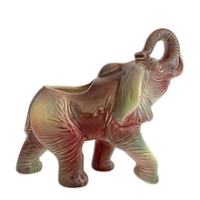 Load image into Gallery viewer, Vintage mid-century era figural lucky elephant ceramic plant in shakes of cranberry, green, yellow and gray. Marked Made in USA. Bring some luck to your gardening with this sweet, trunk up, planter!
In excellent condition, no chips/cracks/repairs.
Measures 9 x 4 x 7 7/8 inches