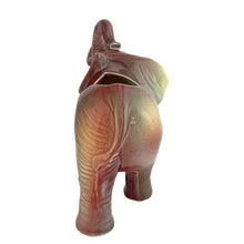 Load image into Gallery viewer, Vintage mid-century era figural lucky elephant ceramic plant in shakes of cranberry, green, yellow and gray. Marked Made in USA. Bring some luck to your gardening with this sweet, trunk up, planter!
In excellent condition, no chips/cracks/repairs.
Measures 9 x 4 x 7 7/8 inches