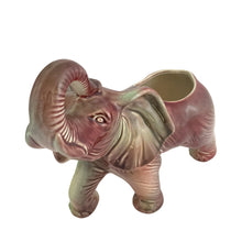 Load image into Gallery viewer, Vintage mid-century era figural lucky elephant ceramic plant in shakes of cranberry, green, yellow and gray. Marked Made in USA. Bring some luck to your gardening with this sweet, trunk up, planter!
In excellent condition, no chips/cracks/repairs.
Measures 9 x 4 x 7 7/8 inches