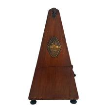 Load image into Gallery viewer, Classic obelisk shaped antique mahogany cased Metronome with brass fittings. Designed and patented by Maëlzel and manufactured by Paquet, France, early 20th century. Serial number 353.455. The brass plate on the cover reads, Paris, France, Angleterre, Amérique, Hollande, Belgique. Remove the cover to reveal the steel timing arm and tempo scale against a dark stained background.