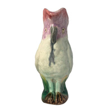 Load image into Gallery viewer, Antique majolica figural white and pink cockatoo parrot ceramic pitcher with green botanical base and brown bamboo-style handle. Crafted by Georges Jones, England, in the late 19th century (1880s). A wonderful piece of whimsical majolica for any collector and lends itself nicely to a tropical or Tiki themed decor!
In good used vintage condition, no chips. Age-related crazing and typical manufacturing glaze bubbles present. See photos.
Measures 5 x 2 1/2 x 6 inches