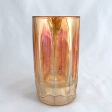 Load image into Gallery viewer, Vintage marigold carnival glass handled beer mug with exceptional iridescence! Crafted by the Jeannette Glass Company, USA, circa 1920s and 1930s. Enjoy a cold one in this special piece of glass!
In excellent condition, free from chips/cracks.
Measures 3 x 5 1/2-inches tall
Capacity 10 ounces