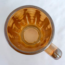Load image into Gallery viewer, Vintage marigold carnival glass handled beer mug with exceptional iridescence! Crafted by the Jeannette Glass Company, USA, circa 1920s and 1930s. Enjoy a cold one in this special piece of glass!
In excellent condition, free from chips/cracks.
Measures 3 x 5 1/2-inches tall
Capacity 10 ounces
