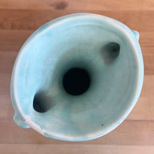 Load image into Gallery viewer, Beautiful vintage Art Deco matte aqua leaf topped handled vase. Crafted by McCoy Pottery, 1940s. This vase is must for any art pottery collector!
In as found vintage condition, area at the rim where glaze has come away, no chips/cracks/repairs. Maker's mark on the bottom.
Measures 5 1/4 x 9 1/4 inches
