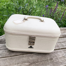Load image into Gallery viewer, Vintage retro style cream or off-white coloured hard shell make-up travel case. with original blue interior, mirror, plastic line bottom, tray and ID tag. Crafted by L. McBrine Company Limited, Canada in Kitchener, Ontario Canada! Circa 1960/70s. This brings back all the feels of travelling in style! In good vintage condition with appropriate age-related wear. No key. Tray has a hairline crack, but still intact and useable. Measures 14 1/4 x 9 1/4 x 8 5/8 inches luggage