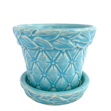 Load image into Gallery viewer, McCoy Tierra Cushion aqua planter, three-quarter front view showing the full embossed diamond and leaf pattern with creamy white glaze pooling in the relief