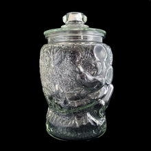Load image into Gallery viewer, Super fun, vintage embossed Mickey Mouse clear glass lidded jar. Perfect for cookies and dry goods storage. Whether you're a collector or just a Walt Disney fan, this Libbey-made canister is a must-have!
In excellent condition, free from chips. Note there is a rough mold release on one side of the lid seam.
Measures 7 1/2 x 12 3/4 inches