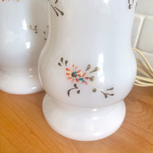 Load image into Gallery viewer, A beautifully shaped pair of vintage milk glass table lamps featuring hand painted flowers in orange, green and gold. Perfect for adding vintage charm to any space. In as found vintage condition, glass is free from chips/cracks, paint is worn. Tested and in working order. Measures 3 7/8 x 12 1/4 inches