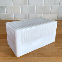 Load image into Gallery viewer, Vintage style milk glass butter dish lid features raised ribs and the word "BUTTER" in reverse on the inside. Crafted by Abbott Industries. Even without it's bottom, this is a versatile piece that could be repurposed as a catchall, for bath accessories or as a planter. In excellent condition, no chips. Measures 5 5/8 x 3 1/8 x 2 3/4 inches