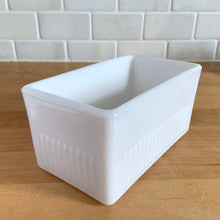 Load image into Gallery viewer, Vintage style milk glass butter dish lid features raised ribs and the word "BUTTER" in reverse on the inside. Crafted by Abbott Industries. Even without it's bottom, this is a versatile piece that could be repurposed as a catchall, for bath accessories or as a planter. In excellent condition, no chips. Measures 5 5/8 x 3 1/8 x 2 3/4 inches