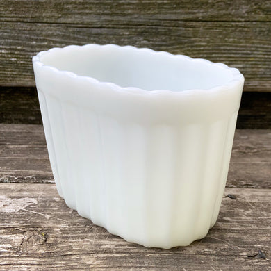 A heavy vintage milk glass vase with a ribbed body and scalloped edge. Crafted by Vase-Mate, circa 1950s. A versatile piece of mid-century glass that could be used as intended, or repurposed as a pen holder, make-up brush holder, candy/nut dish, etc.  In excellent condition, free from chips. Marked 