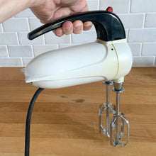 Load image into Gallery viewer, Fabulous vintage white and black Sunbeam Mixmaster Junior hand mixer, Model J. Crafted by the Sunbeam Corporation, USA, circa 1950. The power and quality craftsmanship of these mixers is unmatched and are made to last a lifetime. A must-have for any baker or appliance collector!
Tested. In good working order.
Mixer measures 7 1/4 x 3 x 6 inches (10 3/4 inches tall with beaters)