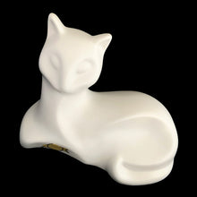 Load image into Gallery viewer, A striking example of vintage MCM craftsmanship, this matte cream art pottery cat embodies the minimalist aesthetic that defined 1960s modernism with its geometric lines and understated elegance. Crafted by the acclaimed Laurentian Pottery studio in Québec, Canada. Its sculptural form and subtle finish have earned it recognition among serious collectors of MCM design and Canadian ceramics, making it a coveted addition to curated collections.
Excellent condition, no chips/cracks/repairs. Original sticker.