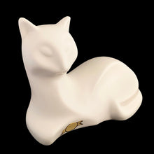 Load image into Gallery viewer, A striking example of vintage MCM craftsmanship, this matte cream art pottery cat embodies the minimalist aesthetic that defined 1960s modernism with its geometric lines and understated elegance. Crafted by the acclaimed Laurentian Pottery studio in Québec, Canada. Its sculptural form and subtle finish have earned it recognition among serious collectors of MCM design and Canadian ceramics, making it a coveted addition to curated collections.
Excellent condition, no chips/cracks/repairs. Original sticker.