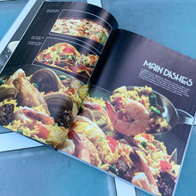 Load image into Gallery viewer, Better Homes and Gardens is known for its fabulous cookbooks. This hardcover cookbook focuses on More From Your Wok inspired recipes. Its 96 pages are filled with amazing recipes along with many colour photographs. Originally published by Meredith Corporation, USA, 1982. Ninth printing 1990 shows that this was a very popular cookbook! In excellent condition.