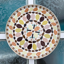 Load image into Gallery viewer, A fabulous vintage mid-century mosaic tile dish featuring acorns and leaves plus various shapes and sizes of tiles in shades of brown, yellow, pink, orange and green...all the colours of autumn. Crafted by Albright Manor, Canada, circa 1960s. The tiles are grouted in white on a gold-toned round metal dish. Perfect as wall art or a dish. A great retro dish to use as a catchall or wall art! In excellent condition. Measures 11 3/4 x 1 1/8 inches