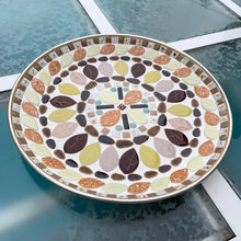 Load image into Gallery viewer, A fabulous vintage mid-century mosaic tile dish featuring acorns and leaves plus various shapes and sizes of tiles in shades of brown, yellow, pink, orange and green...all the colours of autumn. Crafted by Albright Manor, Canada, circa 1960s. The tiles are grouted in white on a gold-toned round metal dish. Perfect as wall art or a dish. A great retro dish to use as a catchall or wall art! In excellent condition. Measures 11 3/4 x 1 1/8 inches