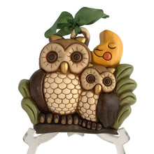 Load image into Gallery viewer, Vintage hand painted ceramic wall hanging featuring a mother and baby owl perched on a branch under a smiling moon in shades of brown, cream, green, yellow, orange and gold. Crafted by Thun, Italy, 1980s. Highly collectible and adorable wall decor for any room in your home!
In excellent condition, no chips/cracks/repairs. Embossed mark and original sticker.
Measures 8 5/8 x 7 3/4 x 2 1/8 inches
