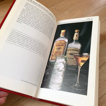 Load image into Gallery viewer, The original vintage Mr. Boston Official Bartender's and Party Guide written by Leo Cotton and published in 1935. This is the 1996 edition published by Warner Books, USA. A fantastic 272 page reference book jam packed with practical info and cocktail recipes to add to your bar. A great gift for any mixologist. This book makes it easy to whip up some mid-century cocktails!
In good used condition. There is typical foxing on the interior pages and a couple of small dog-tagged ears.