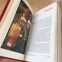 Load image into Gallery viewer, The original vintage Mr. Boston Official Bartender's and Party Guide written by Leo Cotton and published in 1935. This is the 1996 edition published by Warner Books, USA. A fantastic 272 page reference book jam packed with practical info and cocktail recipes to add to your bar. A great gift for any mixologist. This book makes it easy to whip up some mid-century cocktails!
In good used condition. There is typical foxing on the interior pages and a couple of small dog-tagged ears.
