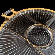 Load image into Gallery viewer, Vintage "National" 15 Inch round 6 part clear glass raVintage National 15 Inch round 6-part clear glass relish with handles and gold trim features a central hobnail section with ribs emanating to the eelish with handles and gold trim features a central hobnail section with ribs emanating to the edges which make it look like a flower. Crafted by Jeannette Glass, USA. Perfect for serving veggies, dips or antipasto. In good vintage condition, free from chips. There is minor wear to the gold. Measures 15 inches