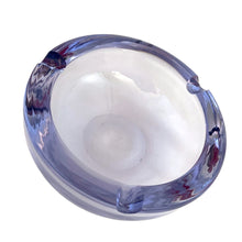 Load image into Gallery viewer, Vintage mid-century modern purple and blue alexandrite neodymium modernist art glass round ashtray. Bohemia Glass, Czechoslovakia, circa 1950s. The unique properties of alexandrite glass allow it to change colour in different types of light triggered by the use of Neodymium in the production of the crystal. Under fluorescent light, it appears blue and under incandescent or natural light, it appears purple. A stunning piece of art glass!
In excellent condition. Measures 4 3/8 x 1 7/8 inches