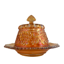 Load image into Gallery viewer, Side profile of Northwood Grape & Cable marigold carnival glass covered butter dish, showing lid finial and sawtooth rim of base dish, c. 1910