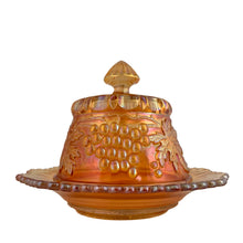 Load image into Gallery viewer, Rear view of Northwood Grape & Cable marigold carnival glass covered butter dish, highlighting oil-slick iridescence on pressed glass surface, c. 1910