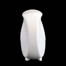 Load image into Gallery viewer, A delicate and elegant art nouveau style white bisque flower vase featuring embossed ocean wave design and glazed on the inside. Impressed "M. Frey" signature and shape number "678". Crafted by Kaiser, Germany. A lovely vase to fill with a sweet bouquet of fresh or dried flowers In excellent condition, free from chips/cracks/repairs. Measures 4 x 4 inches