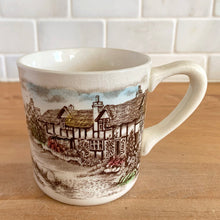 Load image into Gallery viewer, Johnson Bros Old English Countryside mug, front view showing Tudor cottage transferware scene with colourful garden and blue sky, vintage crazing visible
