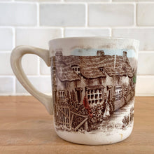 Load image into Gallery viewer, Johnson Bros Old English Countryside mug, opposite side view showing figure in cottage garden, thatched rooftops, and age-appropriate crazing on white earthenware