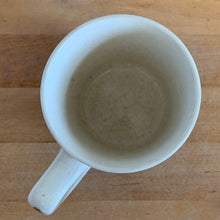Load image into Gallery viewer, Overhead view into Johnson Bros Old English Countryside mug showing plain white interior with light age patina