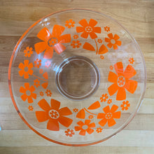 Load image into Gallery viewer, This vintage mid-century era large clear glass chip or salad bowl features graphic orange flowers. Crafted by Anchor Hocking, USA, 1960s. Fill this set with your favourite snacks or salads. The perfect serving piece to brighten up your next party, movie night, game night or get-together. Makes a wonderful housewarming, bridal shower, or birthday gift!
The glass is in excellent overall condition, no chips, minor wear.
Measures 10 3/4 x 5 7/8 inches