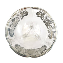 Load image into Gallery viewer, A lovely round clear glass tri-footed bowl featuring art deco pattern of silver overlay orchids and scalloped rim. Glass blank crafted by Viking Glass and overlay applied by Silver City, USA, circa 1940s. A lovely piece for candies, snacks or trinkets.
In excellent condition, no chips.
Measures 6 x 2 1/2 inches
