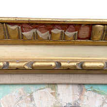 Load image into Gallery viewer, Close-up of top frame rail showing gilt egg-and-dart molding with significant plaster loss and exposed red bole ground on Herbert Otto Fiedler framed oil painting, circa 1940s