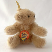 Load image into Gallery viewer, Vintage Original Teddy miniature beige bear made beige mohair. He has a brown hand embroidered nose and mouth, black beaded eyes and his head is jointed and bendable limbs. Silver button-in-ear with yellow tag. His chest has the red, blue and yellow white tag. Steiff, Germany, 1969 - 1977. A must-have for any Steiff or teddy bear collector! In excellent condition. Purchased from the original owner who kept it in a display case. Measures 2 3/4 inches or 7cm tall