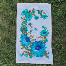 Load image into Gallery viewer, A vintage pale blue ultra soft cotton terry cloth bath towels featuring a striking spray of flowers in shades of turquoise, blue and green with an inset scalloped border pattern. Crafted by Besana, Italy. This gorgeous towel is sure to amplify your bath! In excellent condition, free form tears/stains. Possibly new old stock. Measures 47 inches x 27 1/2 inches