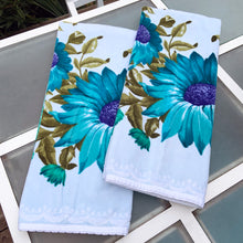 Load image into Gallery viewer, A vintage pale blue ultra soft cotton terry cloth bath towels featuring a striking spray of flowers in shades of turquoise, blue and green with an inset scalloped border pattern. Crafted by Besana, Italy. This gorgeous towel is sure to amplify your bath! In excellent condition, free form tears/stains. Possibly new old stock. Measures 47 inches x 27 1/2 inches