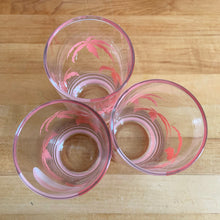 Load image into Gallery viewer, The tropical graphics are the standout feature of these vintage mid-century Panache highball glass tumblers decorated with pink palm trees against a beautiful sunset. Designed by Wolly Clark, circa 1950s. These glasses will definitely add some sweet beachy vibes to your cocktails!  These glasses are in like-new condition, free from chips/cracks/dishwasher damage.  Measures 2 1/2 x 6 1/2 inches  Capacity 13 1/2 ounces