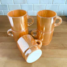 Load image into Gallery viewer, Vintage Fire-King peach lustre milk glass C-handled stackable mug. Crafted by Anchor Hocking, USA, 1950s. These highly collectible mugs are hard to find! In excellent vintage condition, no chips, minor wear. Measures 3 x 3 3/8 inches Capacity 8 ounces