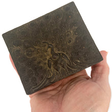 Load image into Gallery viewer, This gorgeous handmade vintage metal lidded trinket box features an embossed proud peacock atop the hinged lid with florals on the side set against a graphic repeating scalloped pattern. The interior is lined with navy blue velvet and the exteriors heavy patina adds to the beauty of the well-crafted box. A stunning piece that will add a bit of mysterious Bohemian whimsy to your decor! In good vintage condition. South East Asian origin. Measures 3 5/8 x 3 x 1 1/2 inches