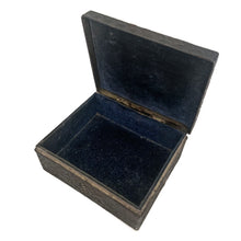 Load image into Gallery viewer, This gorgeous handmade vintage metal lidded trinket box features an embossed proud peacock atop the hinged lid with florals on the side set against a graphic repeating scalloped pattern. The interior is lined with navy blue velvet and the exteriors heavy patina adds to the beauty of the well-crafted box. A stunning piece that will add a bit of mysterious Bohemian whimsy to your decor! In good vintage condition. South East Asian origin. Measures 3 5/8 x 3 x 1 1/2 inches