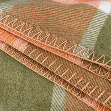 Load image into Gallery viewer, Close-up of the blanket stitch edge detail along the orange and green plaid border