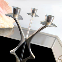 Load image into Gallery viewer, Vintage modernist pewter 3-arm candelabra features a sculptural atomic design that holds three taper candles. Crafted by Brodrene Mylius (BM), Norway, 1960s. An excellent example of mid-century Scandinavian decor.
In excellent condition. Maker's mark, Pewter B M Norway 36500.
Measures 6 x 6 x 6 1/2 inches
