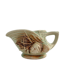 Load image into Gallery viewer, Striking vintage gloss glazed Pinecone creamer in shades of green and brown. Crafted by McCoy Pottery, 1946. Complete your tea set with this rare creamer, a must for any McCoy art pottery collector. Makes a nice complement to your Christmas, cottage or lodge decor!
In good vintage condition, manufacturer's defect on rim, no cracks/repairs, crazing commensurate with age, Maker's mark on the bottom.
Measures 5 3/4 x 3 1/8 x 2 7/8 inches