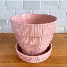 Load image into Gallery viewer, Highly collectible vintage mid-century pink basketweave ceramic planter with attached underplate. Crafted by McCoy Pottery, 1950s. The perfect home for your favourite houseplant or succulent and a must-have for any art pottery collector!
In excellent vintage condition, no chips/cracks/repairs, age-related crazing. Maker's mark.
Measures 6 1/2 x 5 5/8 inches