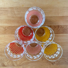 Load image into Gallery viewer, Glassware dreams are made of these beauties! This is a fantastic set of six vintage mid-century beverage glasses decorated in pairs with a pink, yellow or red basketweave pattern topped with a band of white ivy. Produced by Federal Glass, circa 1950s. The perfect addition to any style vintage kitchen and your tablescape will thank you! In like new condition, free from chips/wear. The paint is vibrant and shiny. Unmarked. Measures 2 1/2 x 4 1/2 inches Capacity 12 ounces
