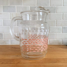 Load image into Gallery viewer, Fantastic vintage mid-century beverage pitcher decorated with a pink basketweave pattern topped with a band of white ivy and ribbed handle. Produced by Federal Glass, circa 1950s. The perfect addition to any style vintage kitchen and your tablescape will thank you! Glassware dreams are made of this beauty! In like new condition, free from chips/wear. The paint is vibrant and shiny. Unmarked. Measures 5 x 8 inches Capacity 90 ounces