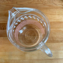 Load image into Gallery viewer, Fantastic vintage mid-century beverage pitcher decorated with a pink basketweave pattern topped with a band of white ivy and ribbed handle. Produced by Federal Glass, circa 1950s. The perfect addition to any style vintage kitchen and your tablescape will thank you! Glassware dreams are made of this beauty! In like new condition, free from chips/wear. The paint is vibrant and shiny. Unmarked. Measures 5 x 8 inches Capacity 90 ounces